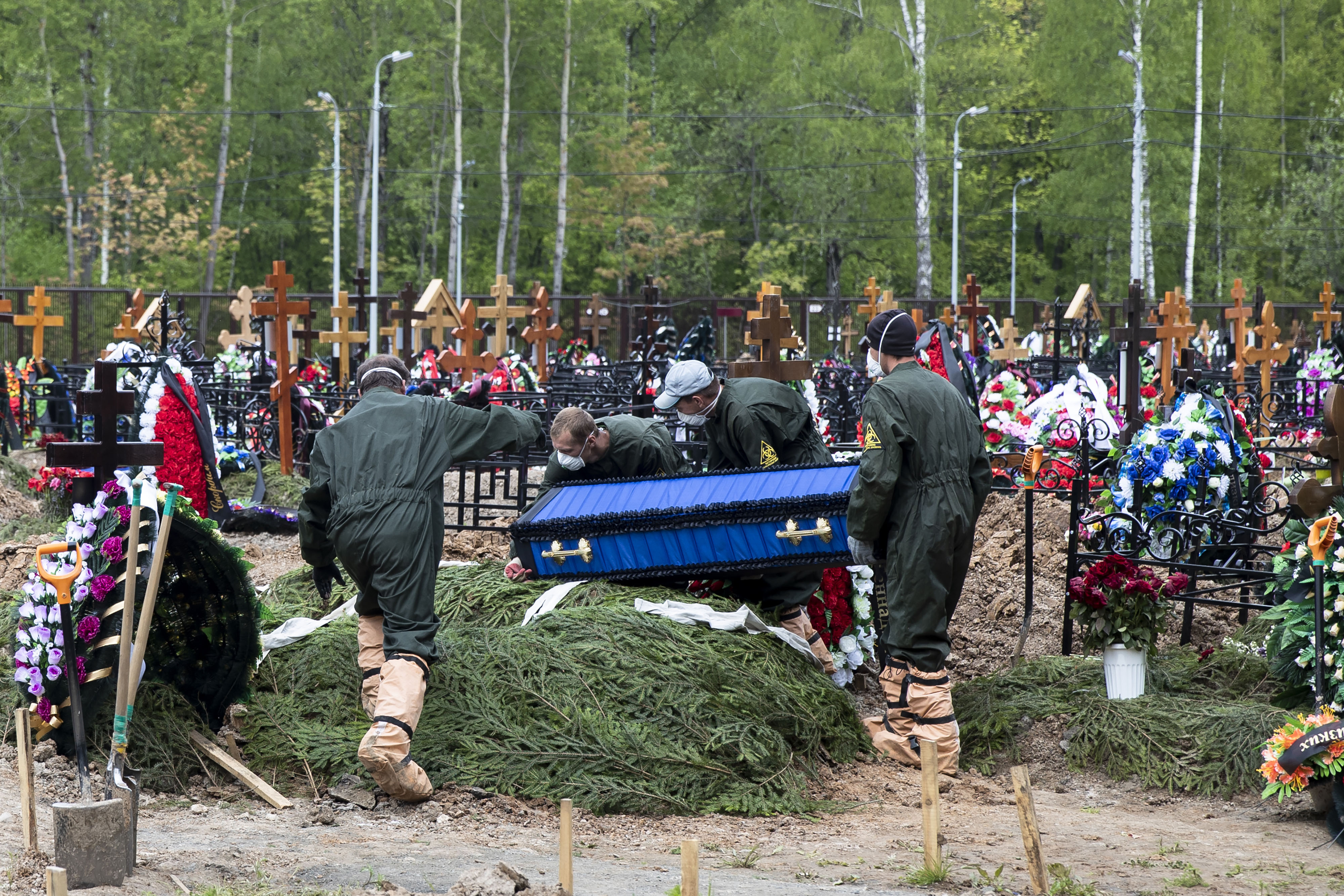 Grave diggers carry the coffin of a Covid-19 patient, in a section of a cemetery reserved for coronavirus victims, outside Moscow on May 26.