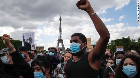 Demonstrators gather on Champs de Mars in front of the Eiffel Tower during a demonstration in Paris on Saturday.