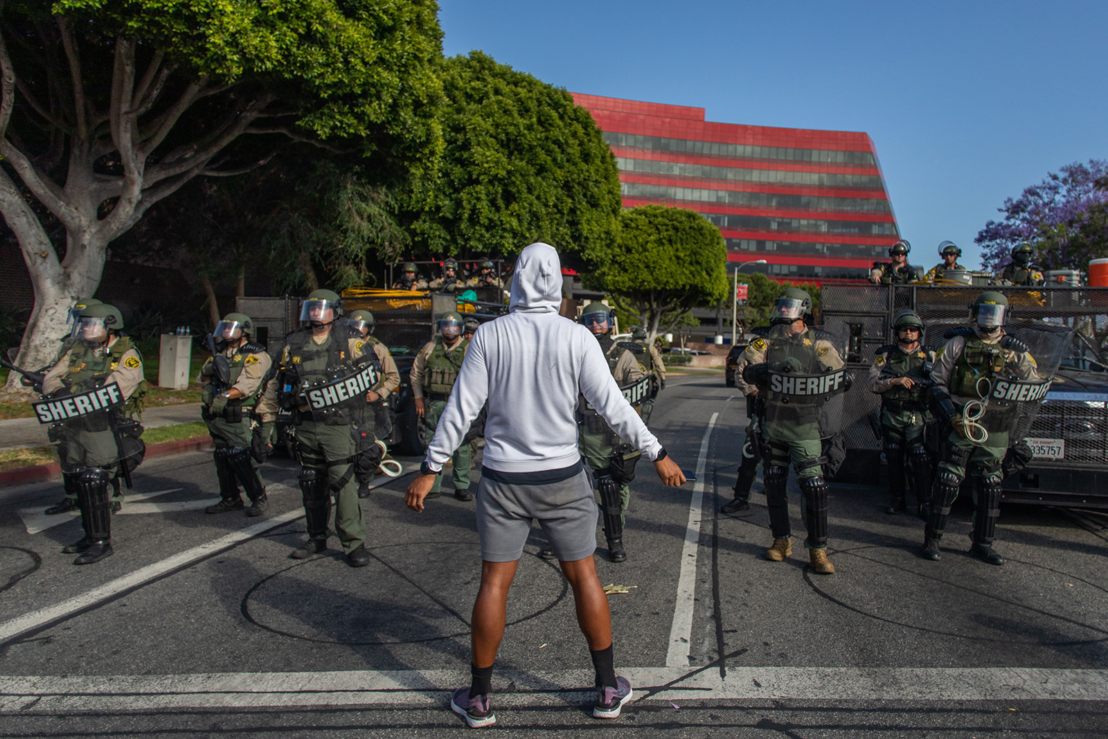 A demonstrator stands in front of the West Hollywood Sheriff's Police Department during a peaceful protest against police brutality and racism in West Hollywood, California on June 6.