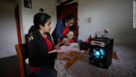 A family listens to one hour of radio lessons from their home in Funza, Colombia, without an internet connection.