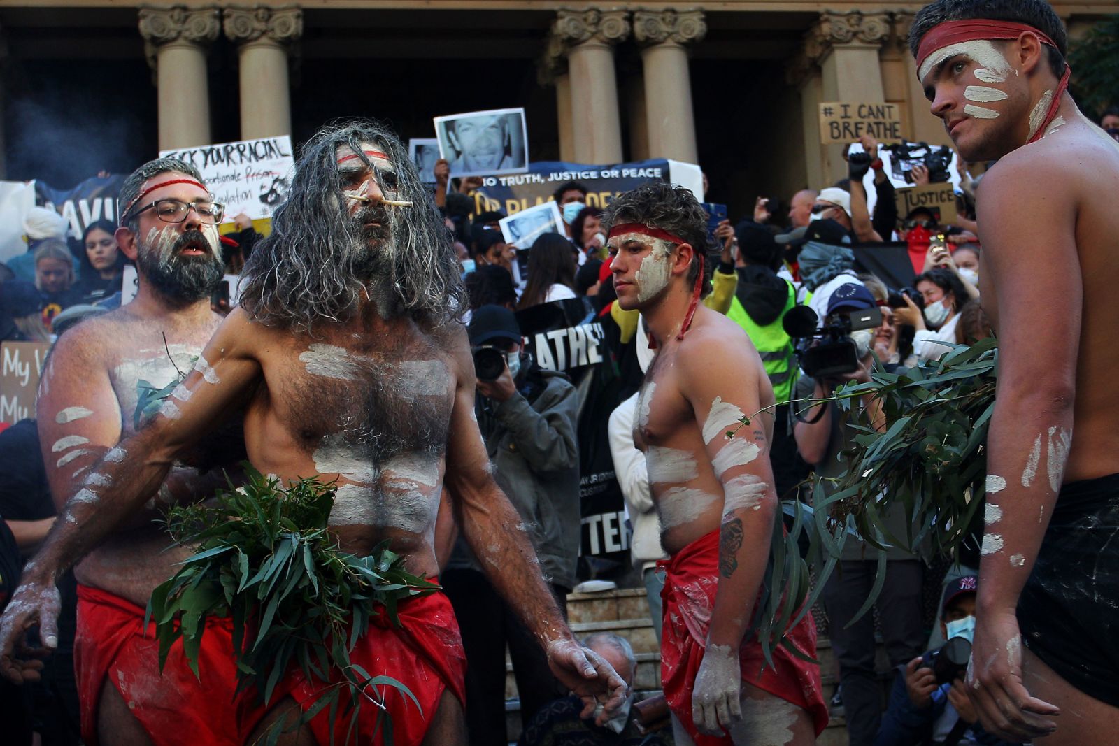 Local protesters hold a traditional smoking ceremony at Town Hall in Sydney, Australia, on June 6th.
