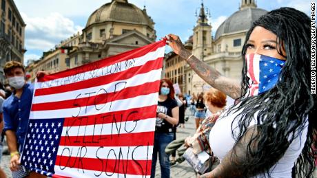 Protesters carry the U.S. flag upside down in Rome.