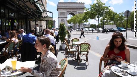 People have lunch at a restaurant near Arc de Triomphe in Paris, France on June 18.