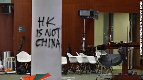 Two days after the protesters enter the complex, graffiti and umbrellas are seen outside the Legislative Council main room during a media tour in Hong Kong on July 3, 2019.