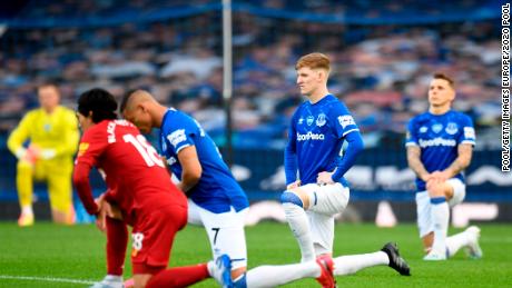 Players and officials are kneeling at Goodison Park to support the Black Lives Matter movement before the Merseyside derby between Everton and Liverpool. 