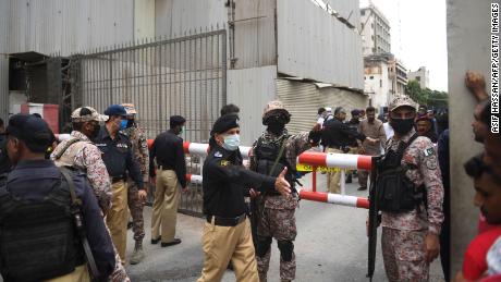 Security personnel gather at the main entrance of Pakistan Stock Exchange building in Karachi on June 29, 2020.