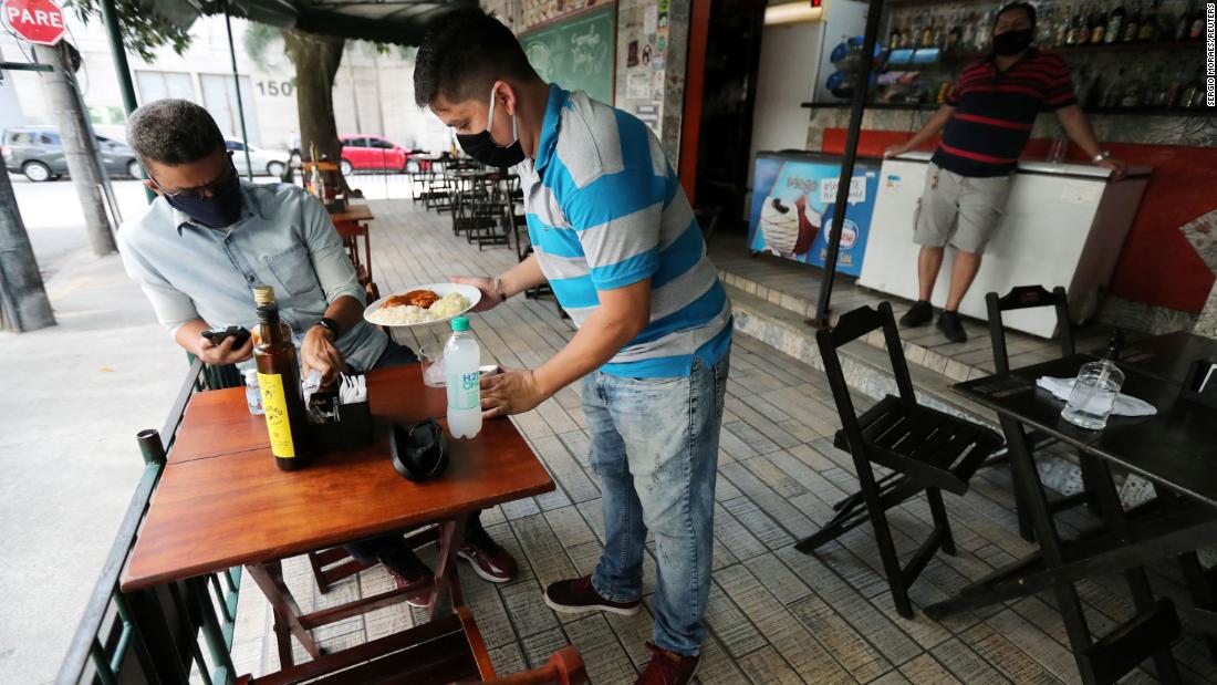 A waiter serves a customer at a bar in Rio de Janeiro on Thursday.