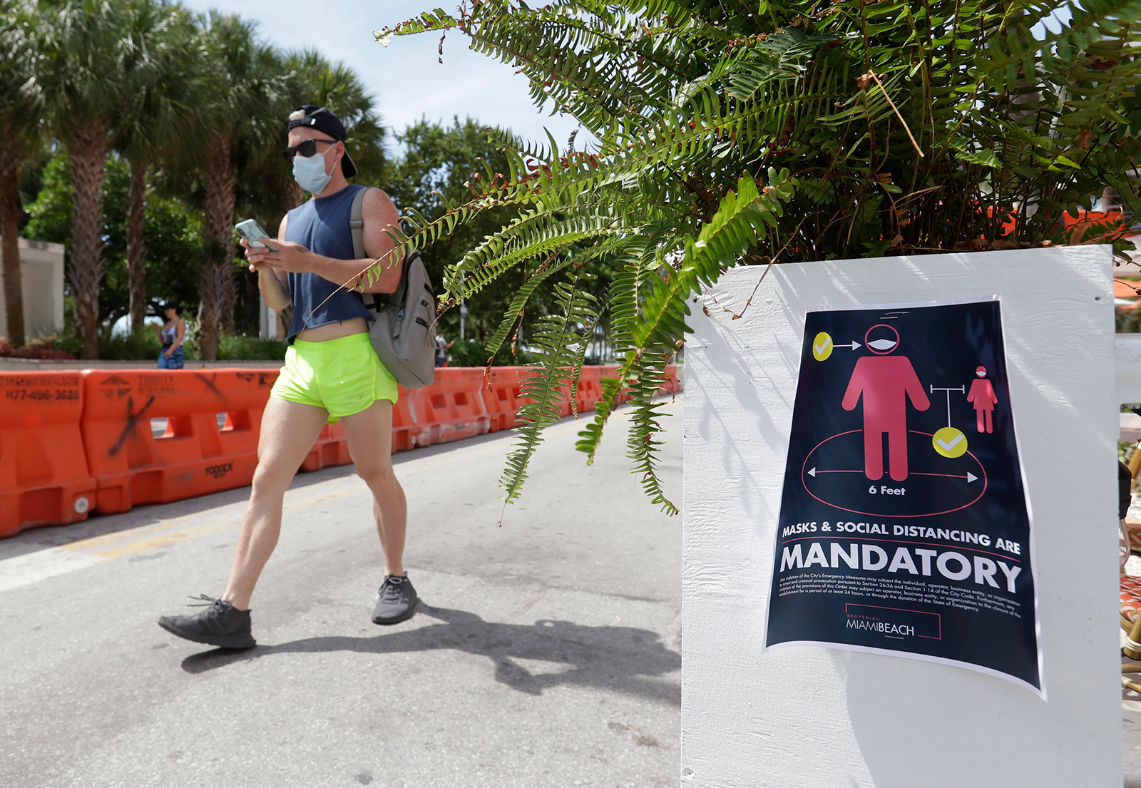 A pedestrian walks down Ocean Drive in Miami July 4.