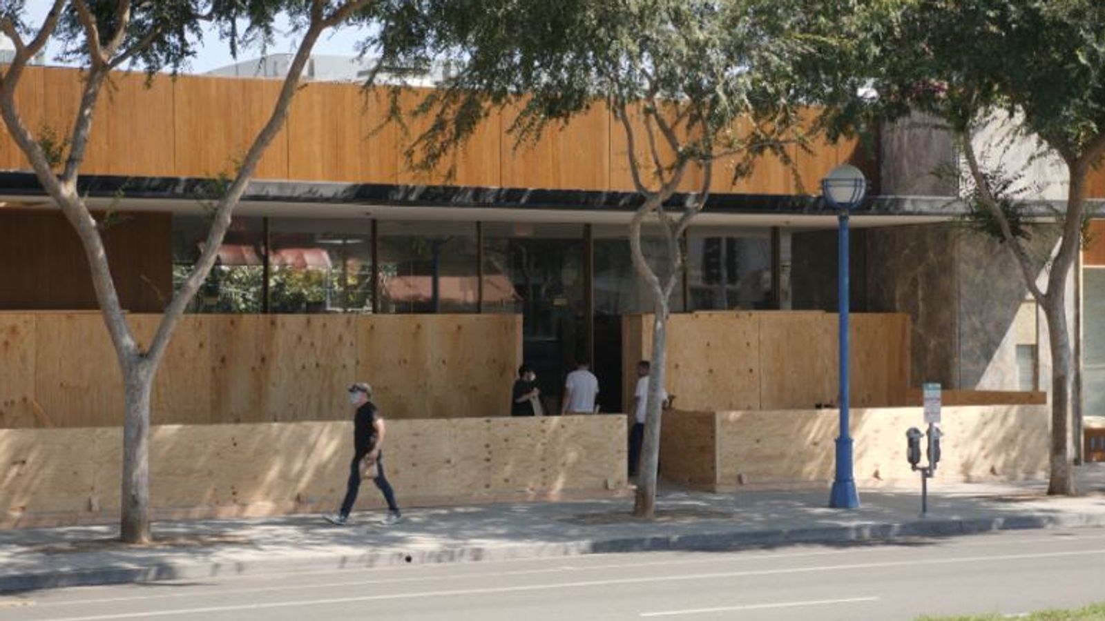A boarded-up shop is seen in West Hollywood  where coronavirus cases are on the rise