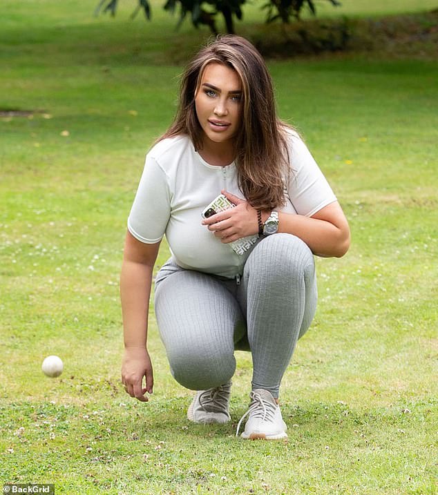 Time for a walk: Lauren Goodger, 33, was once again flaunting her eye-popping curves in tight grey sports leggings as she headed to a park in Essex for another gruelling workout