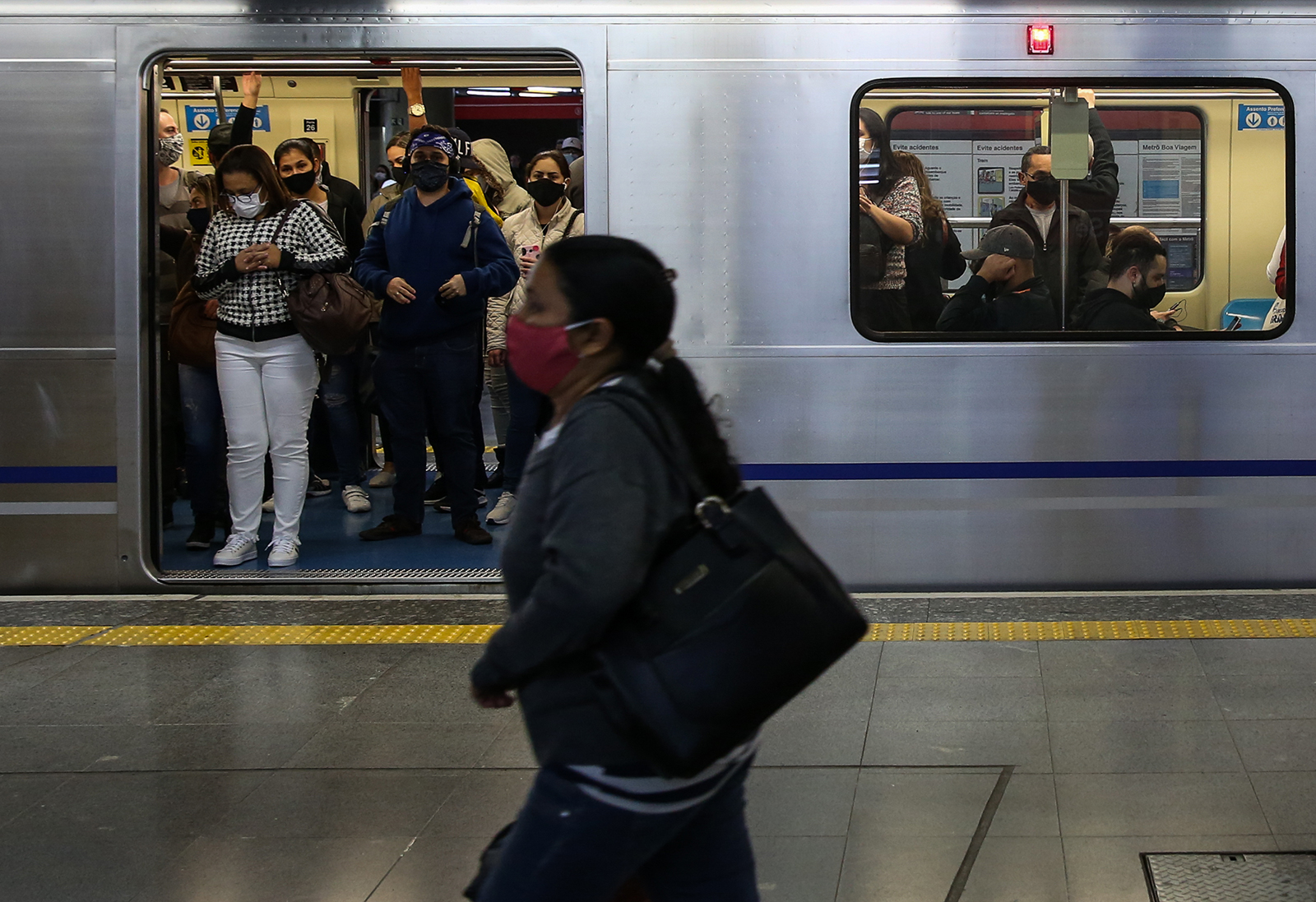 Passengers wearing face masks board a subway in downtown Sao Paulo on June 29 in Sao Paulo, Brazil. 