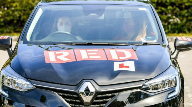 Student driver Roisin Clarke, 17, (L) passed her test when they first resumed in July